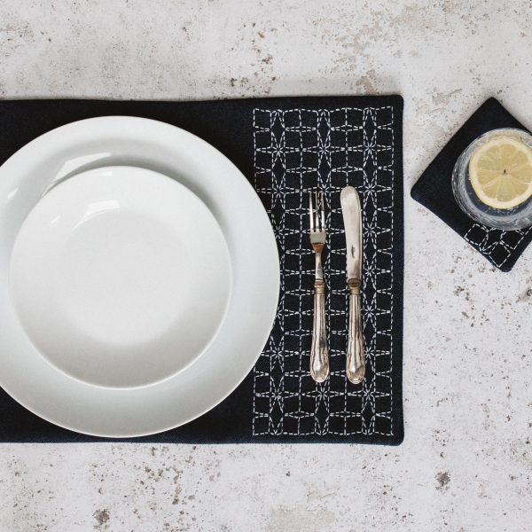 Denim sashiko table mat and coaster, with white china and silver cutlery